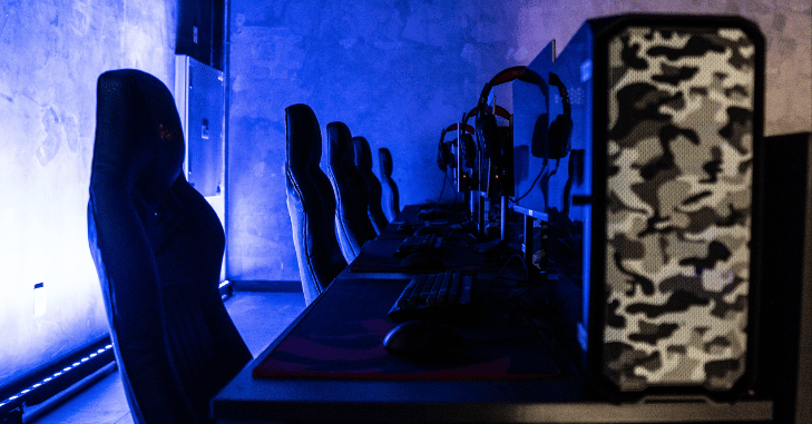 Reclined gaming chair positioned beside a computer desk